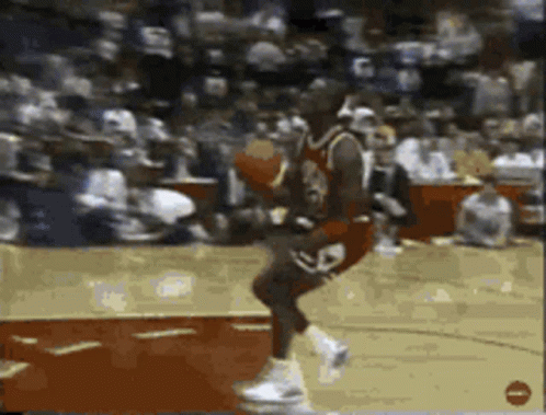 A Basketball Player With The Number 23 On His Jersey Is Jumping In The Air GIF