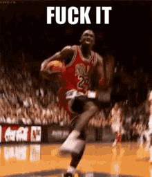 a basketball player with the number 23 on his jersey is jumping in the air while holding a basketball .