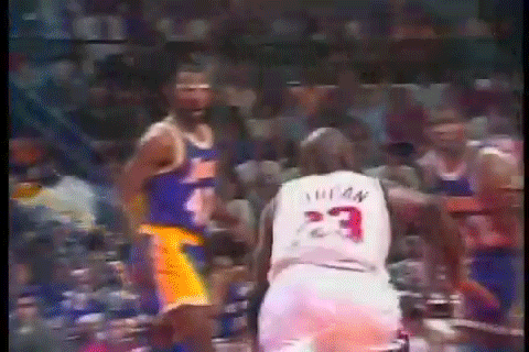 A Basketball Player With The Number 23 On His Jersey Stands Next To Another Player . GIF
