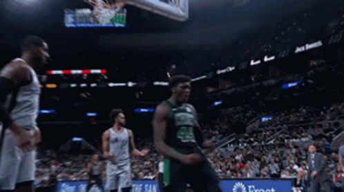 A Basketball Player With The Number 24 On His Jersey Celebrates GIF