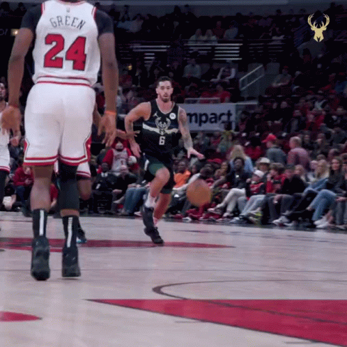 A Basketball Player With The Number 24 On His Jersey Dribbles The Ball GIF