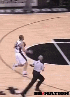 A Basketball Player With The Number 24 On His Jersey Dribbles The Ball GIF