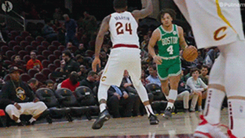 a basketball player with the number 24 on his jersey dribbles the ball