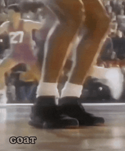 A Basketball Player With The Number 27 On His Jersey Is Jumping On The Court GIF