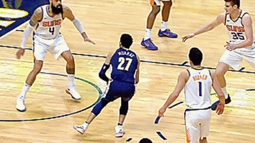 A Basketball Player With The Number 27 On His Jersey Is Playing Defense GIF