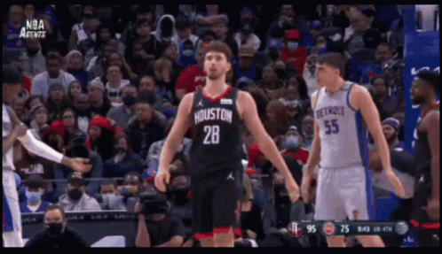 A Basketball Player With The Number 28 On His Jersey Stands In Front Of A Crowd GIF