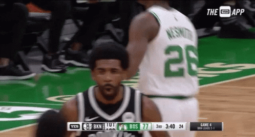 a basketball player with the number 28 on his jersey stands on the court