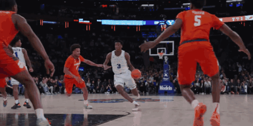 A Basketball Player With The Number 3 On His Jersey Is Dribbling The Ball GIF