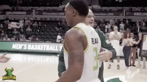 A Basketball Player With The Number 3 On His Jersey Is Hugging Another Player GIF