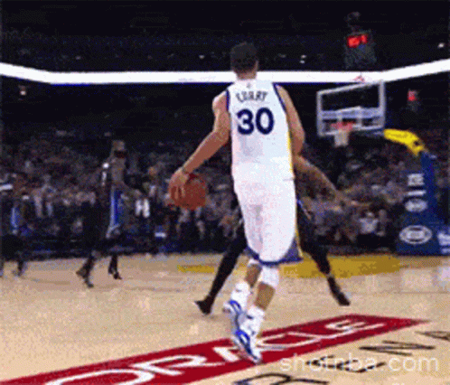 A Basketball Player With The Number 30 On His Back Dribbles The Ball GIF
