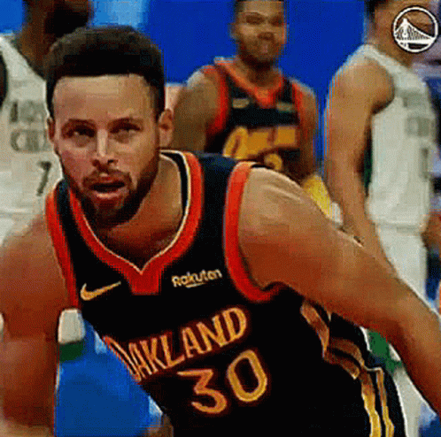 A Basketball Player With The Number 30 On His Jersey Is Dribbling The Ball . GIF