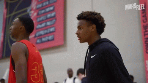 A Basketball Player With The Number 31 On His Jersey Stands Next To Another Player GIF