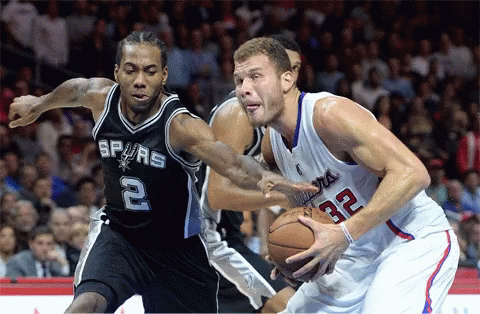 A Basketball Player With The Number 32 On His Jersey Is Dribbling A Basketball GIF