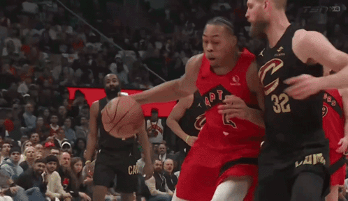 a basketball player with the number 32 on his jersey tries to block another player