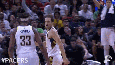 A Basketball Player With The Number 33 On His Back Is Talking To Another Player GIF