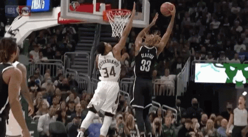 A Basketball Player With The Number 33 On His Jersey Goes Up For A Shot GIF