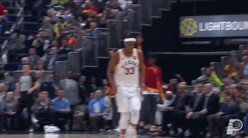 A Basketball Player With The Number 33 On His Jersey Is Walking On The Court GIF