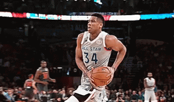 A Basketball Player With The Number 34 On His Jersey Is Dribbling The Ball GIF