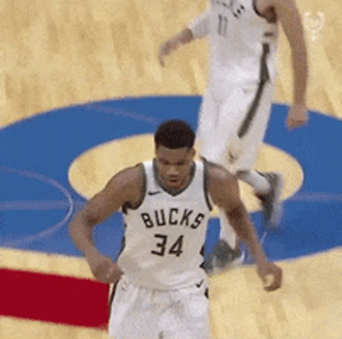 A Basketball Player With The Number 34 On His Jersey Is Running On The Court GIF