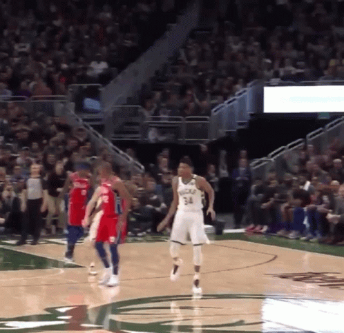 A Basketball Player With The Number 34 On His Jersey Stands On The Court GIF