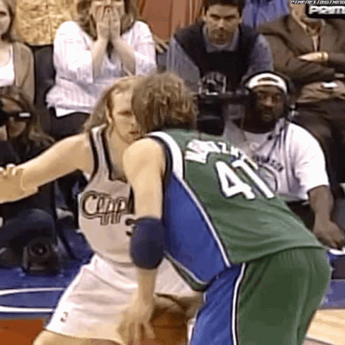 A Basketball Player With The Number 41 On His Jersey Is Being Blocked By Another Player GIF