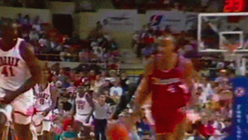 A Basketball Player With The Number 41 On His Jersey Is Being Chased By Another Player GIF