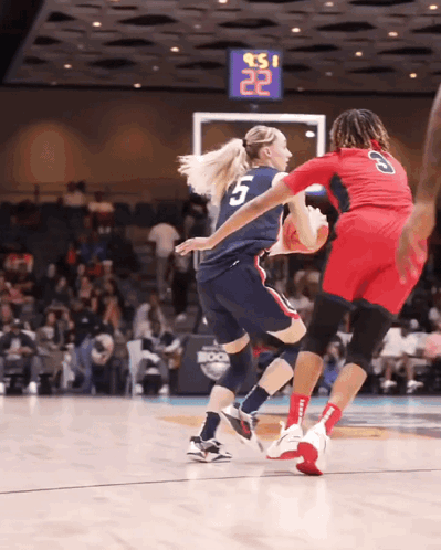 A Basketball Player With The Number 5 On Her Jersey Is Dribbling The Ball GIF