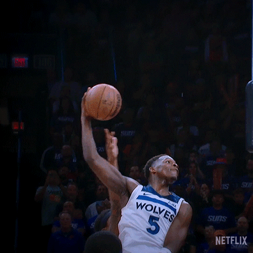 A Basketball Player With The Number 5 On His Jersey Is Dunking The Ball GIF