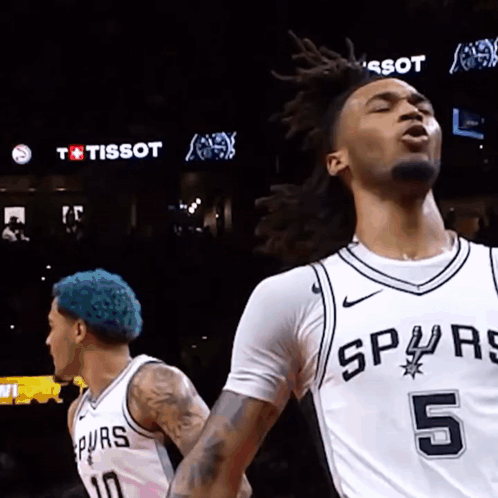 A Basketball Player With The Number 5 On His Jersey Is Standing Next To Another Player GIF
