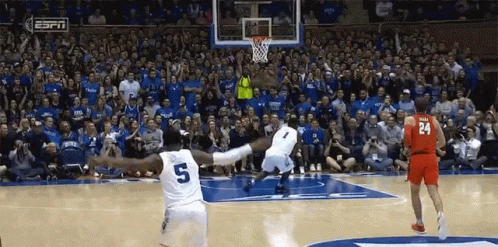 A Basketball Player With The Number 5 On His Jersey Jumps In The Air GIF