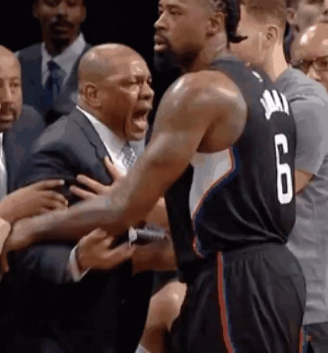 A Basketball Player With The Number 6 On His Jersey Is Being Held By A Man In A Suit GIF