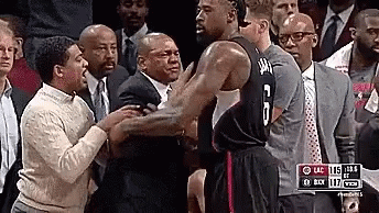 A Basketball Player With The Number 6 On His Jersey Is Standing In Front Of A Crowd . GIF