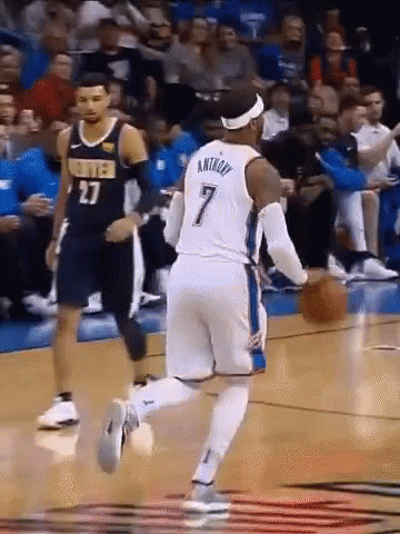 A Basketball Player With The Number 7 On His Jersey Dribbles The Ball GIF