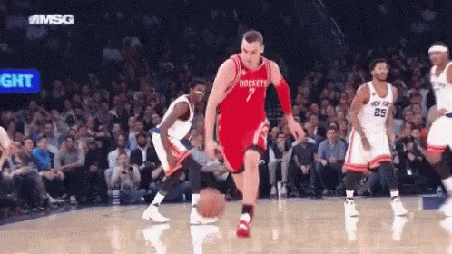 A Basketball Player With The Number 7 On His Jersey Is Dribbling A Basketball GIF