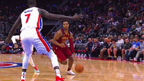 A Basketball Player With The Number 7 On His Jersey Is Dribbling A Basketball GIF