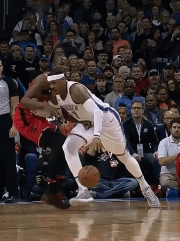 A Basketball Player With The Number 7 On His Jersey Is Dribbling The Ball GIF