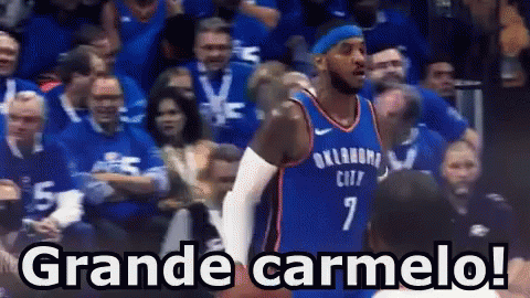 A Basketball Player With The Number 7 On His Jersey Stands In Front Of A Crowd And Says Grande Carmelo ! GIF