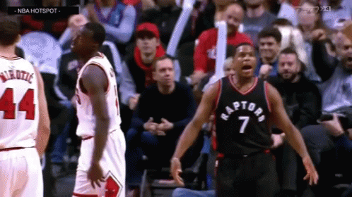 A Basketball Player With The Number 7 On His Jersey Stands In Front Of Another Player GIF
