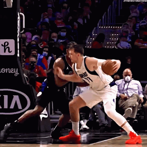 A Basketball Player With The Number 77 On His Jersey Dribbles The Basketball GIF