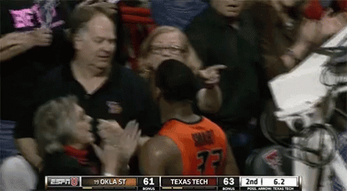 A Basketball Player With The Number 77 On His Jersey Stands In Front Of A Crowd GIF