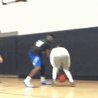 a basketball player with the number 8 on his back dribbles the ball