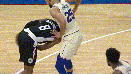 A Basketball Player With The Number 8 On His Back Is Being Tackled By Another Player GIF
