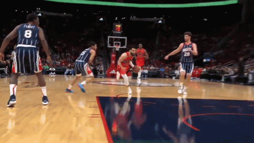 A Basketball Player With The Number 8 On His Jersey Dribbles The Ball GIF