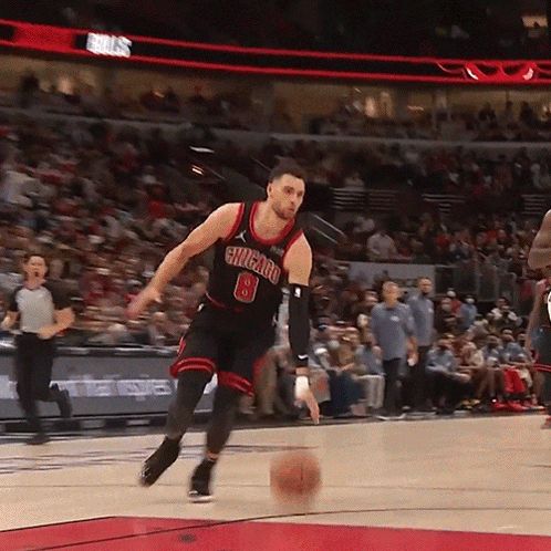 A Basketball Player With The Number 8 On His Jersey Is Dribbling The Ball GIF