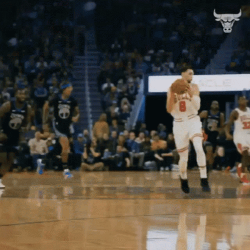 A Basketball Player With The Number 8 On His Jersey Is Holding A Basketball GIF