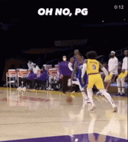 a basketball player with the number 9 on his jersey is trying to block another player