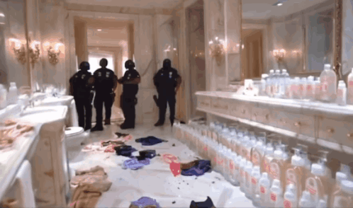 A Bathroom With A Lot Of Baby Bottles And A Few Police Officers GIF