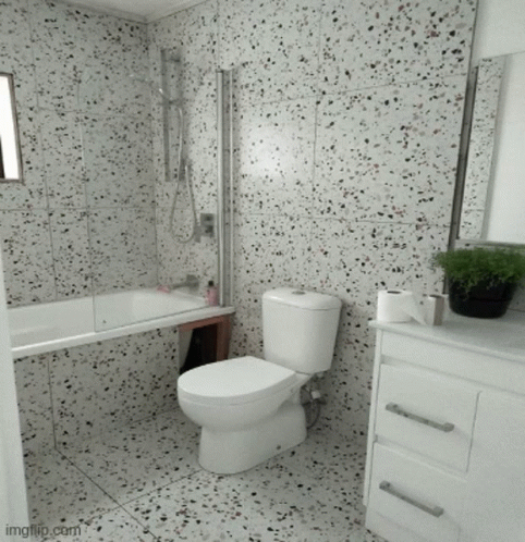 A Bathroom With A Toilet A Sink And A Tub GIF