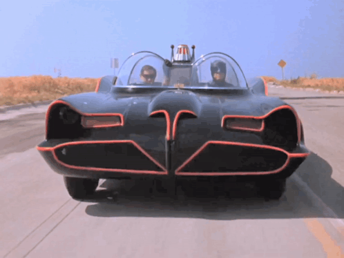 A Batman Car Is Driving Down The Road GIF