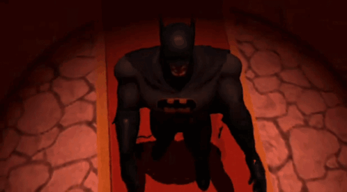 A Batman Laying On A Red Carpet With His Hands Outstretched GIF